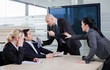 Business man threatning business partner, grabbing him by the ti