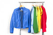 Rainbow clothes on wooden hangers, isolated on white.