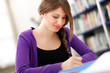 Young female student in a library