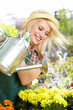 young blond girl with gardening tools