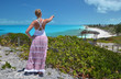 Girl looking along the coastline of Little Exuma, Bahamas
