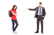Angry father shouting and pointing with his finger at his daught