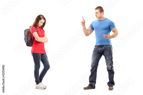 Photo: Angry brother pointing with finger and threatening at his sister Angry brother pointing with finger and threatening at his sister
