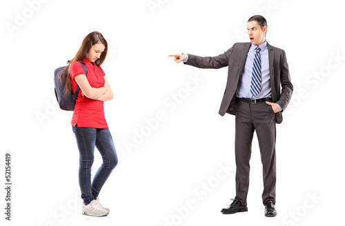 Photo: Angry father shouting and pointing with his finger at his daught Angry father shouting and pointing with his finger at his daught