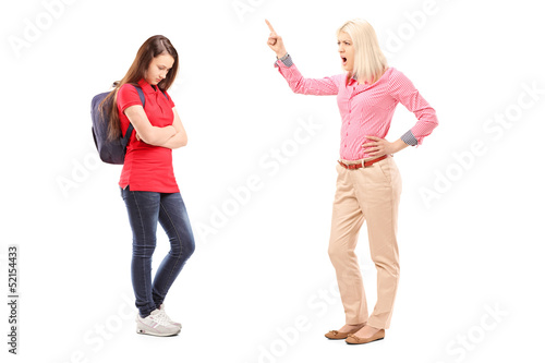 Photo: Full length portrait of an angry mother shouting at her daughter Full length portrait of an angry mother shouting at her daughter