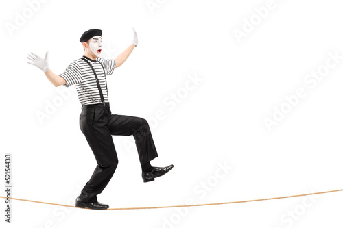 Photo: Full length portrait of an excited male mime artist walking on a Full length portrait of an excited male mime artist walking on a