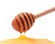 Honey dripping from a wooden honey dipper isolated on white back
