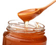 Honey dripping from a wooden honey dipper isolated on white back