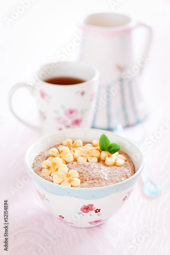 Photo: Oatmeal porridge with banana and flax seed, selective focus Oatmeal porridge with banana and flax seed, selective focus