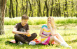 Beautiful happy couple having fruits on picnic