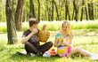 Couple having a picnic date, sitting on the grass