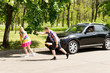 Lazy man watching his girlfriend pull a car