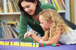Elementary Pupil Counting With Teacher In Classroom