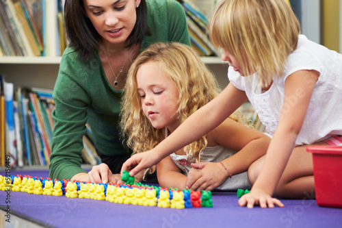 Photo: Elementary Pupils Counting With Teacher In Classroom Elementary Pupils Counting With Teacher In Classroom