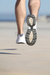 Close up of an unfocused man legs running on the concrete
