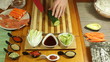 Chopping fresh cucumber for making vegetarian Sushi roll