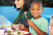 Elementary Pupils Enjoying Healthy Lunch In Cafeteria