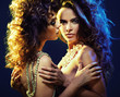 Two curly-haired ladies in sexy hug