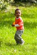 Outdoor portrait of a cute young  little black boy playing with