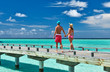 Couple on a beach jetty at Maldives