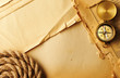 Antique compass and rope over old map