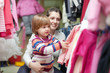 Photo: mother with baby chooses wear at clothes shop mother with baby chooses wear at clothes shop