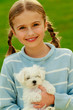 Photo: Lovely girl with cute puppy in the garden Lovely girl with cute puppy in the garden
