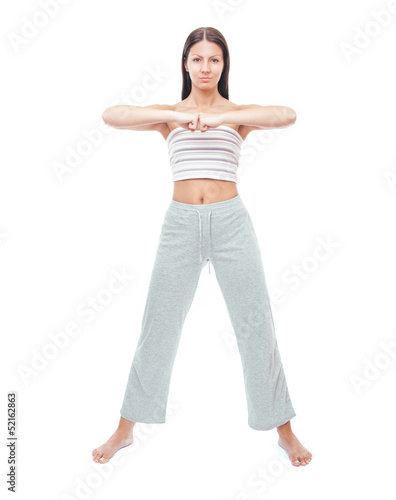 Photo: Pretty young woman doing exercise, full length Pretty young woman doing exercise, full length