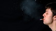 Man coughing as he is smoking