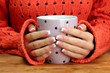 hands holding mug of hot drink, close-up