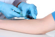 Nurse takes blood from the veins isolated on white