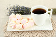 Marshmallows on plate on light background