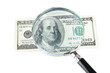 Hundred dollar bill and magnifying glass isolated on white