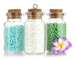 Little bottles full with colorful beads isolated on white