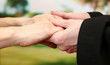Priest holding woman hands, on green background