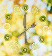 Clock made of kiwi, lime and lemon slices, on bright background