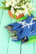 Fork and knife wrapped in blue paper napkin,