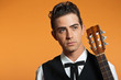 Close-up portrait of retro country male guitar player in black s