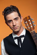 Close-up portrait of retro country male guitar player in black s