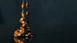 Rosary beads falling onto black surface