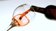 Red wine pouring into a glass low angle view