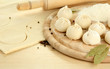 Raw dumplings and dough, on wooden table