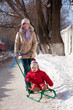  mother with toddler on sled