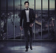 Serious handsome man on the top of the skyscraper