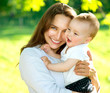 Foto: Mother and Baby outdoors. Happy Family Mother and Baby outdoors. Happy Family
