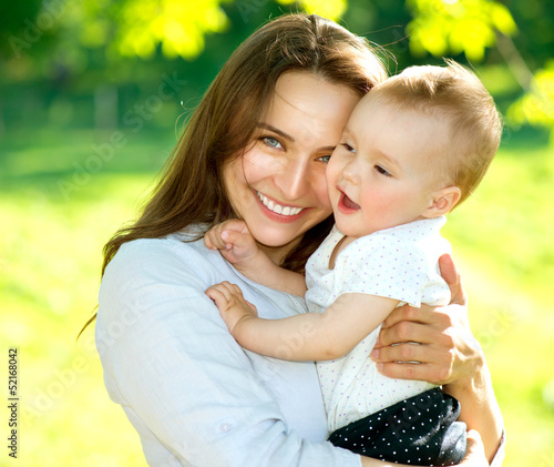 Photo: Mother and Baby outdoors. Happy Family Mother and Baby outdoors. Happy Family