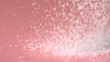 Sugar falling onto pink surface