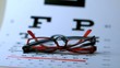 Two pairs of glasses falling on eye test