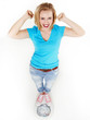 Beautiful girl with scale is proud to lose weight