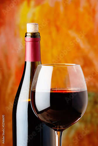 Photo: bottle and glass of red wine bottle and glass of red wine